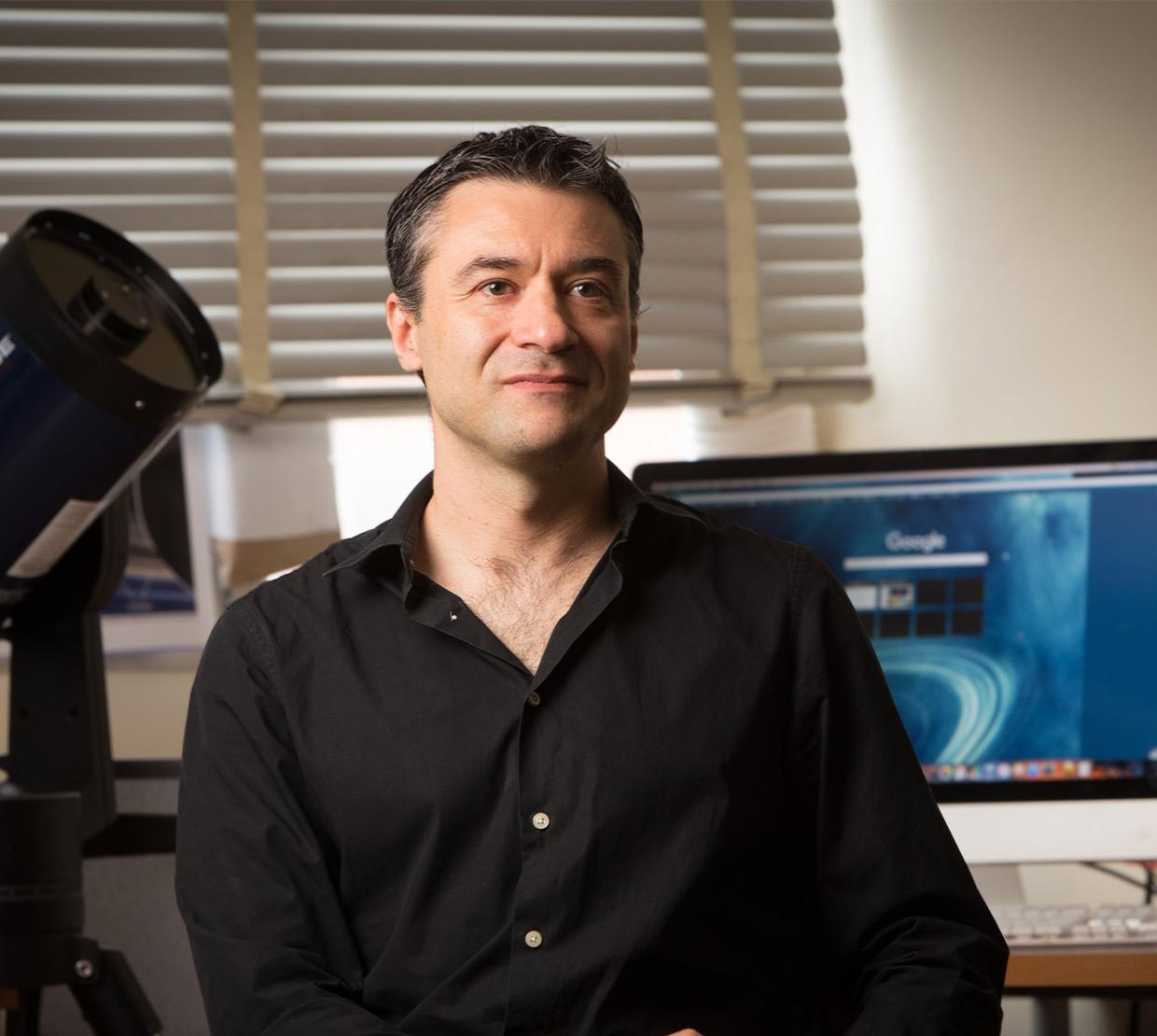 Department of Physics head Davide Lazatti sits in a well-lit office space.