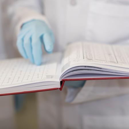 Scientist holding a lab book.